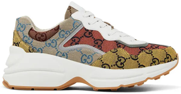 Gucci Women's Rhyton sneaker in multicolor GG monogram canvas with chunky off-white sole and bold patchwork design.

