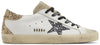 Golden Goose women's Superstar sneaker in optic white leather with seedpearl glitter star and cream suede heel tab, vintage-style distressed sole.


