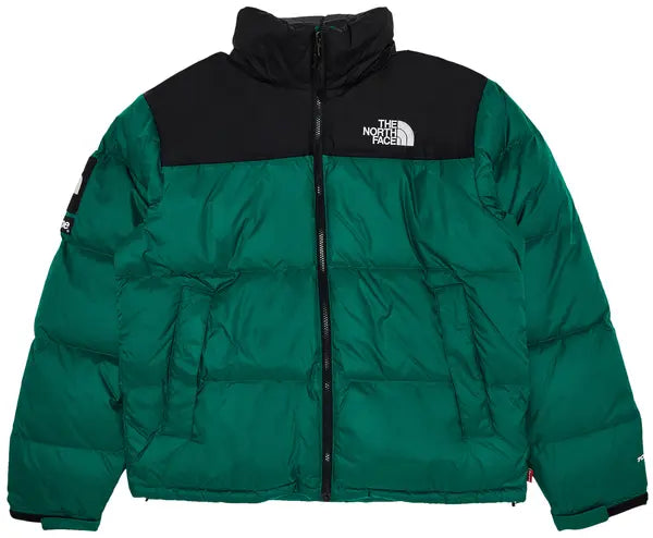 Main Product Shot: Model wearing the green Supreme x The North Face Nuptse puffer jacket outdoors.