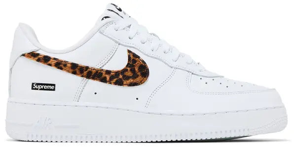 Supreme x GOODENOUGH x Nike Air Force 1 Low 'White Cheetah Print' with white leather upper, brown cheetah-print pony hair Swoosh, and translucent sole revealing co-branding.

