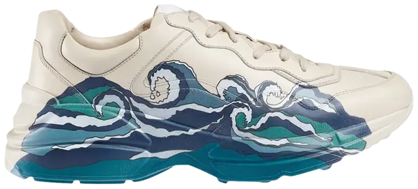 Gucci Wmns Rhyton 'Wave' ivory leather sneaker with blue retro wave graphic and chunky sole.

