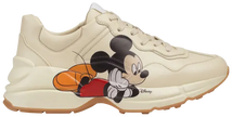 Disney x Gucci women’s Rhyton sneaker in ivory leather with Mickey Mouse print and chunky rubber sole.

