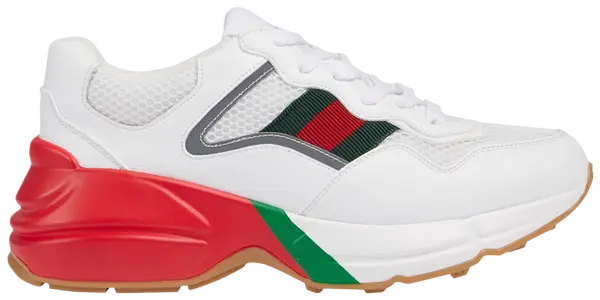 Gucci Women's Rhyton sneaker in white mesh with red and green webbing and reflective detailing on a thick off-white sole.

