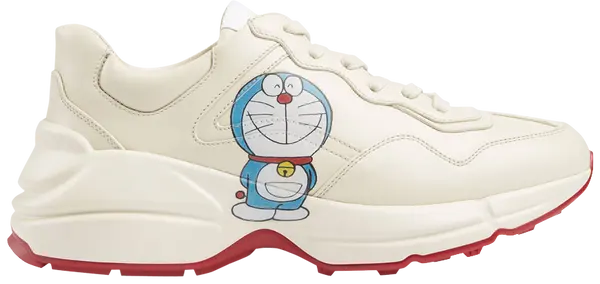 Doraemon x Gucci women’s Rhyton sneaker in ivory leather with all-over character print and chunky sole.


