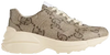 Gucci Wmns 100 Rhyton sneaker in beige and ebony GG monogram canvas with chunky rubber sole.

