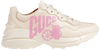 Gucci Wmns Rhyton 'Lemon Gucci' sneaker in cream leather with Lemon Gucci graphic on side.

