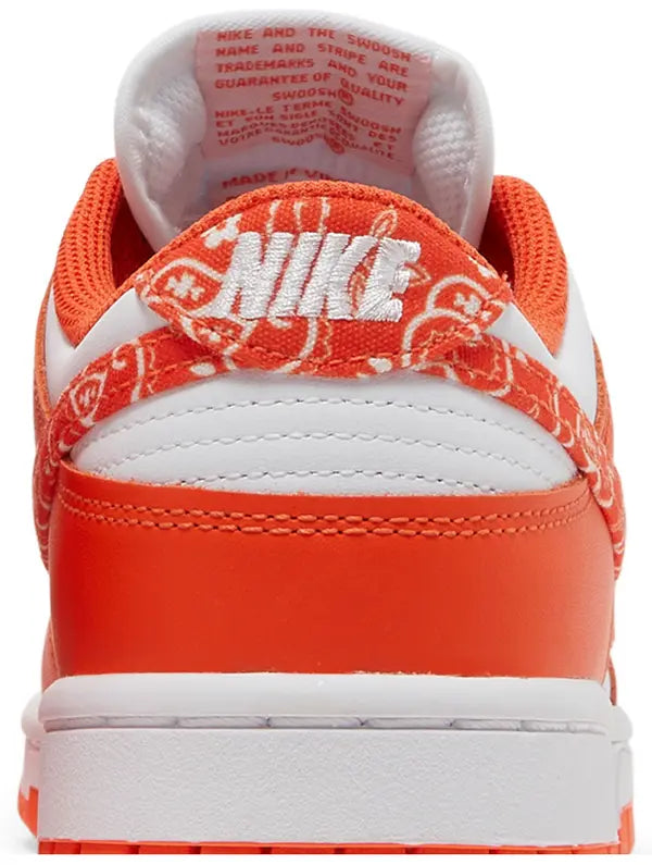 Nike Dunk Low Women’s 'Orange Paisley' sneaker with white leather upper, orange overlays, and paisley print Swoosh.