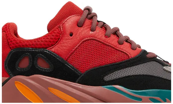 Yeezy Boost 700 ‘Hi-Res Red’ sneaker with red mesh and suede upper, maroon Boost midsole, and multicolor accents.