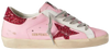 Golden Goose Superstar orchid pink glitter sneaker with distressed leather and red heel tab.