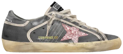 Golden Goose Superstar grey suede sneaker with bubblegum pink glitter star patch on the side.