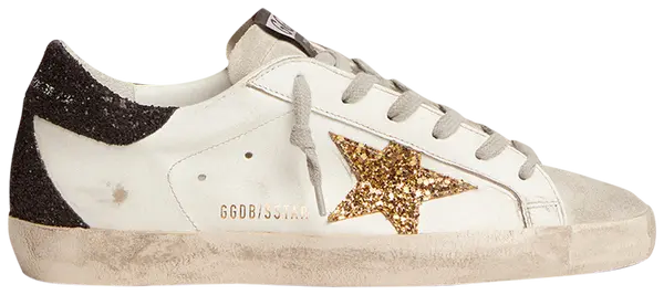 Golden Goose women's Superstar sneaker with gold star, black heel tab, and distressed white leather upper.